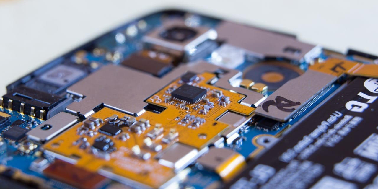 A macro view of the internal printed circuit board of an LG Nexus 5 mobile phone.