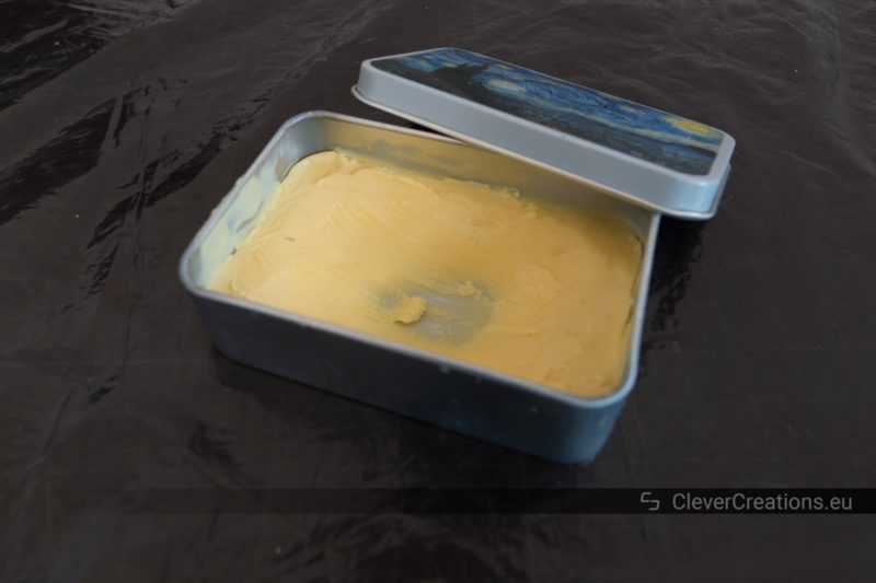 A tin container containing shoe care wax.