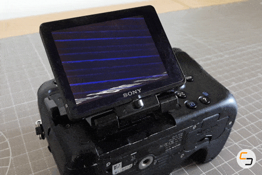 An animated GIF of a broken LCD screen on a Sony SLT-A77 camera.