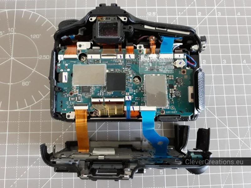 A Sony SLT-A77 camera body with the rear cover removed, visible are the printed circuit boards inside the camera.