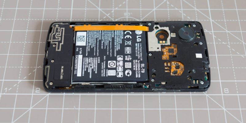 An LG Nexus 5 phone with the back cover removed and the internals visible.