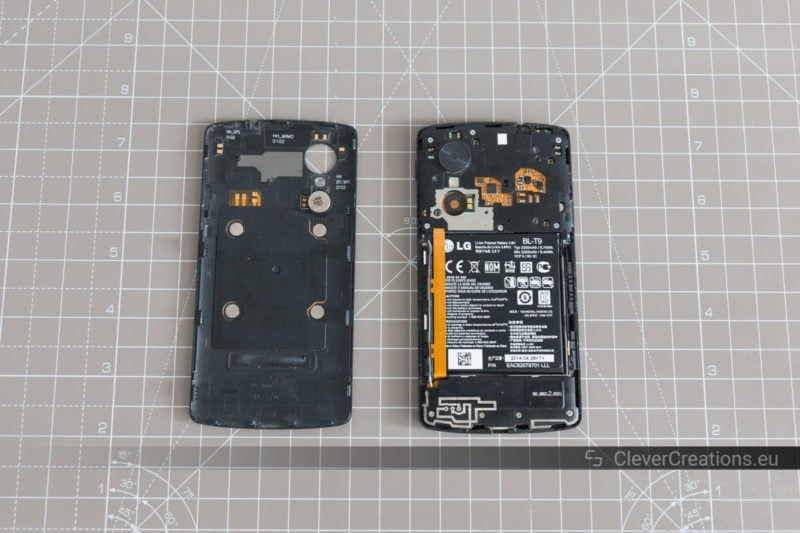 The back cover of an LG Nexus 5 next to the phone itself.