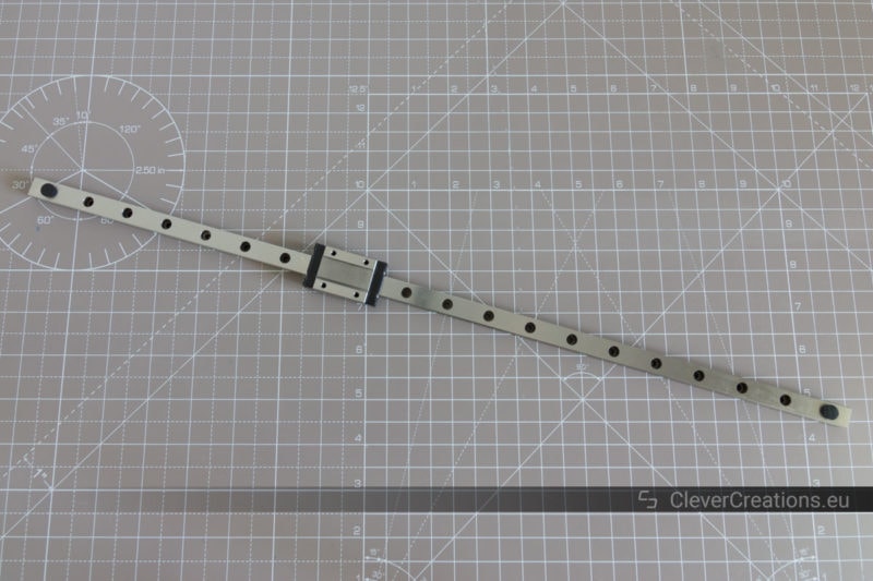 A MGN12 linear rail with carriage on top of a cutting mat.