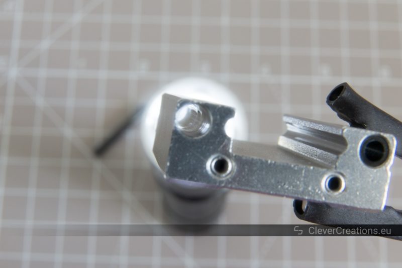 A close-up of one of the ball channels on the inside of a disassembled MGN12H linear rail carriage block.