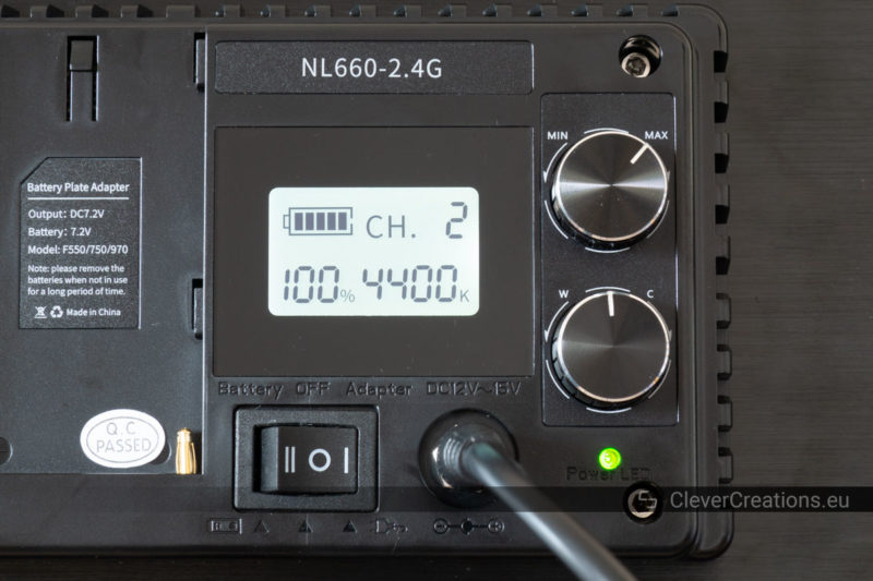 A close-up of the LCD screen and control knobs on the rear of a Neewer 660 light.