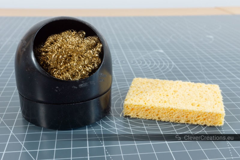 A regular sponge next to a brass sponge for cleaning soldering iron tips.