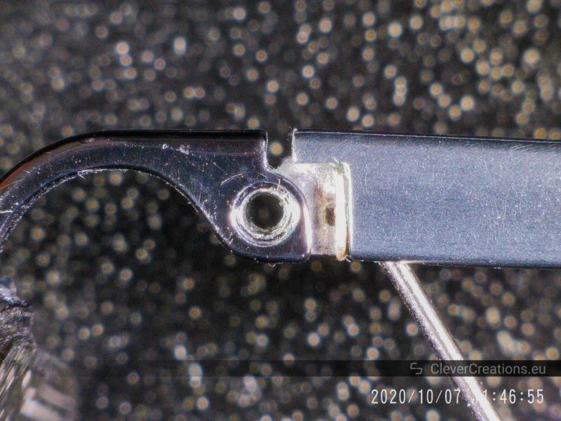 A close-up of properly aligned holes on a spring hinge.