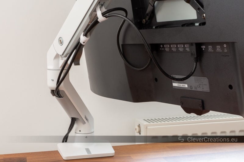 Video and power cables routed through the cable management system of an Ergotron HX monitor arm.