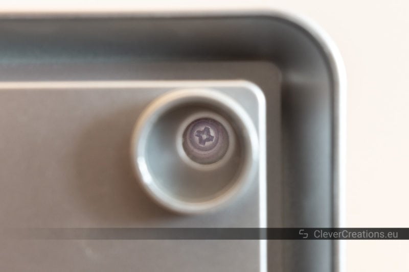 Close-up of a plastic device housing with the exposure locally increased to show a screw.