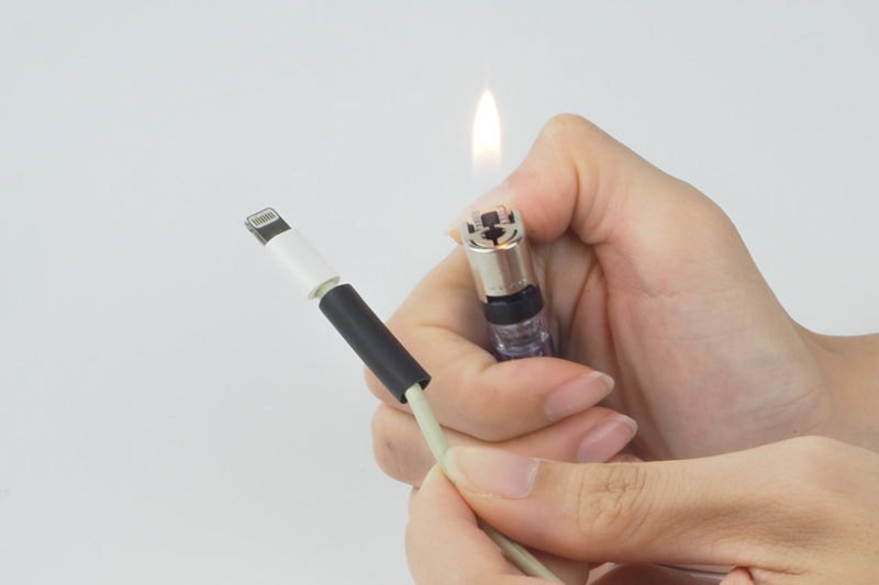 A lighter being used to heat shrink tubing.