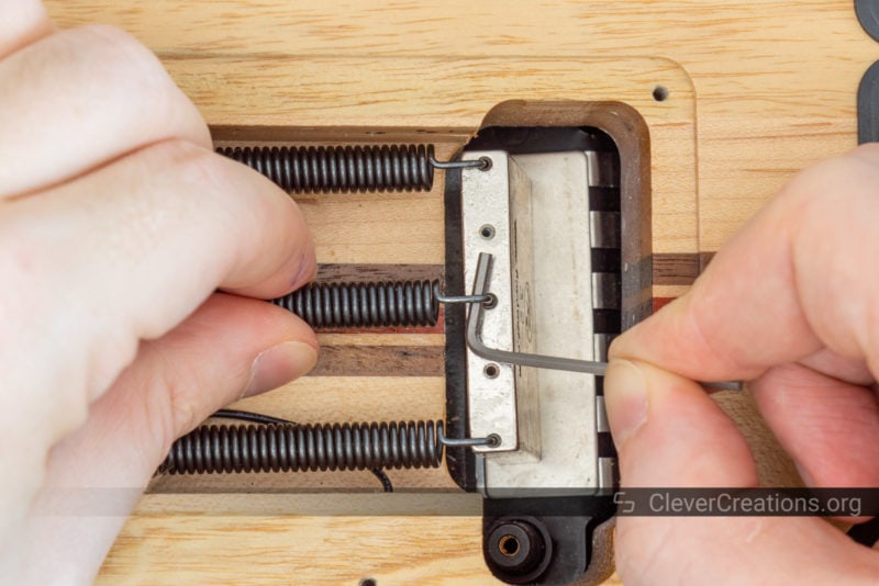 A small hex key used to safely remove a tremolo system spring.