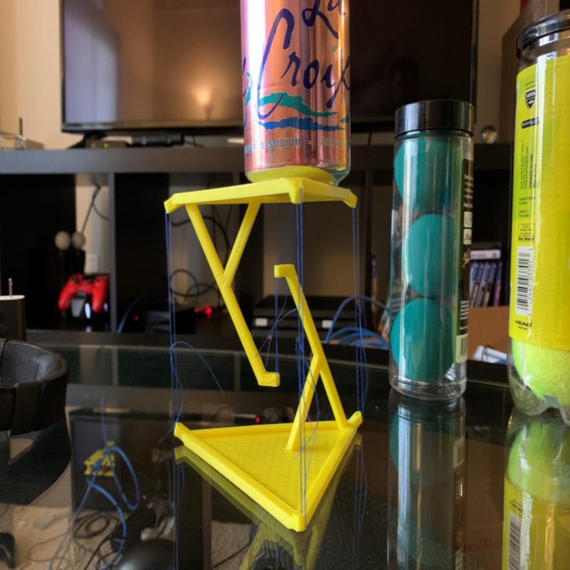 A 3D printed tensegrity table with a drink can on top