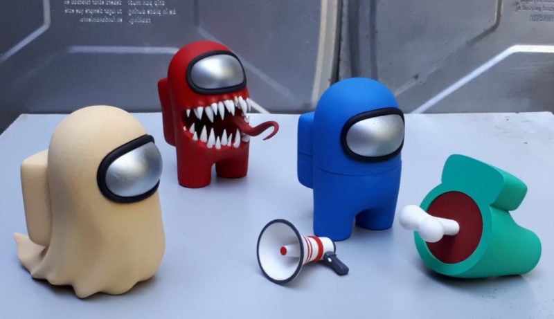 Four 3D printed Among Us figurines in various colors