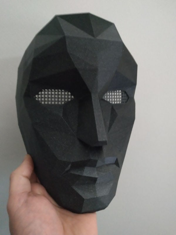 A black 3D printed Squid Game front man mask