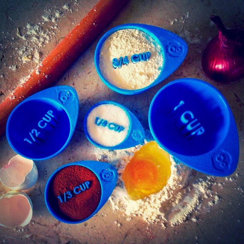 A collection of blue 3D printed measuring cups for in the kitchen