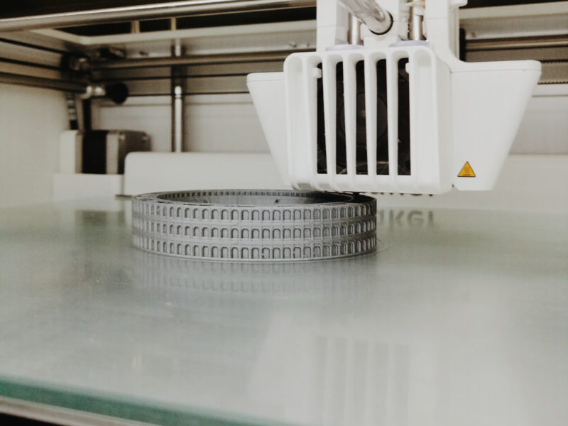 A 3D print of the Colloseum in grey filamet on an Ultimaker