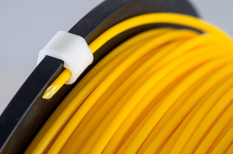 A roll of PLA plus material with filament clip