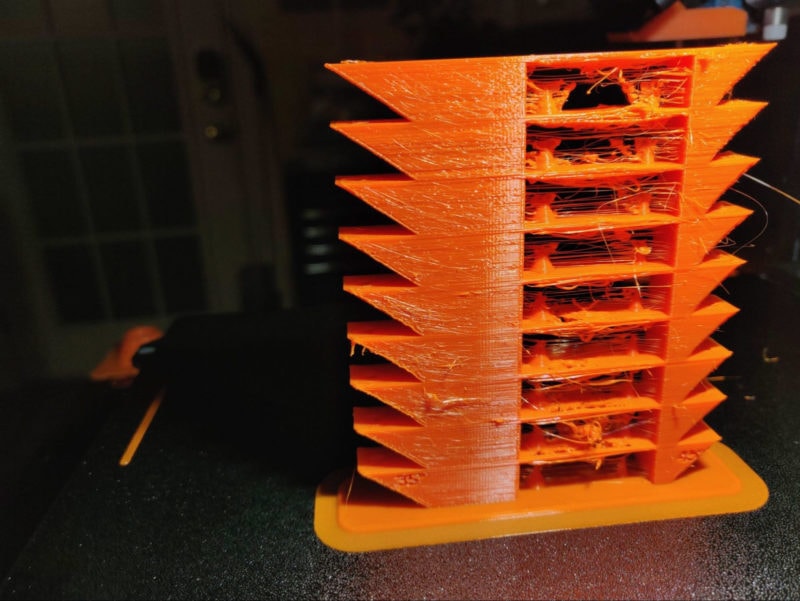A temperature tower with a lot of stringing, blobs and 3D printing artifacts