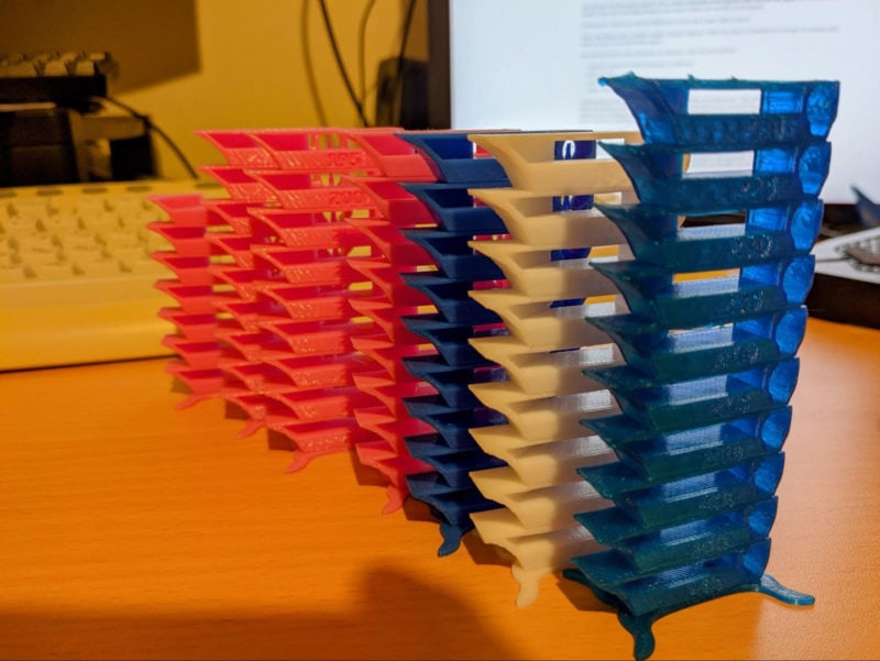 A collection of temperature towers 3D printed in various colors of filament
