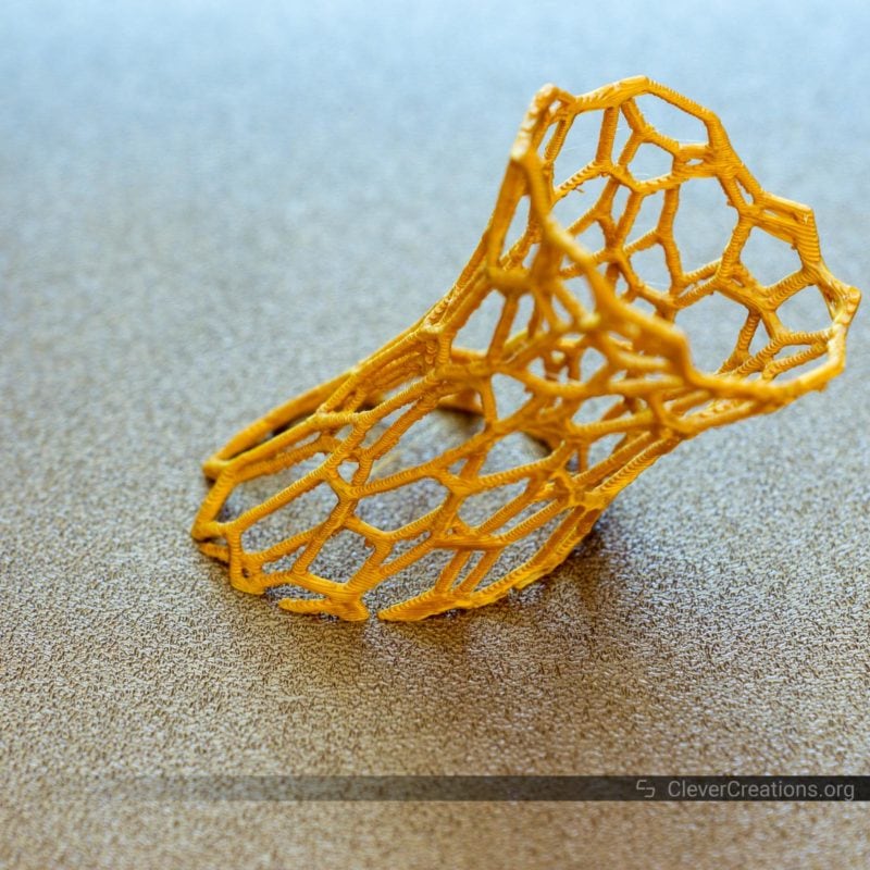 A close-up of a 3D printed voronoi vase component in Formfutura Gold PLA