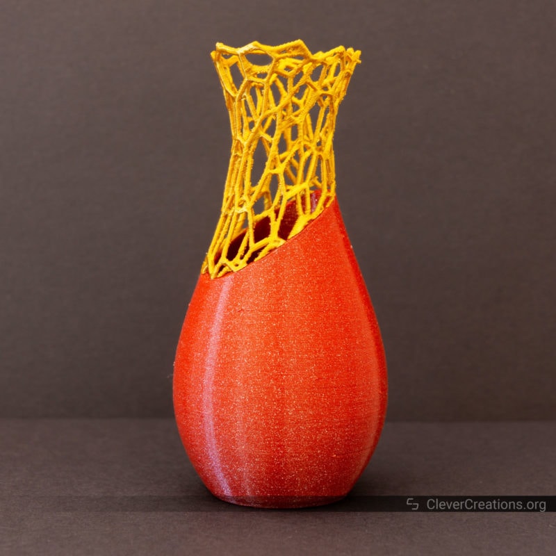 A 3D printed voronoi vase in Glitter Red PLA and high shine Gold PLA