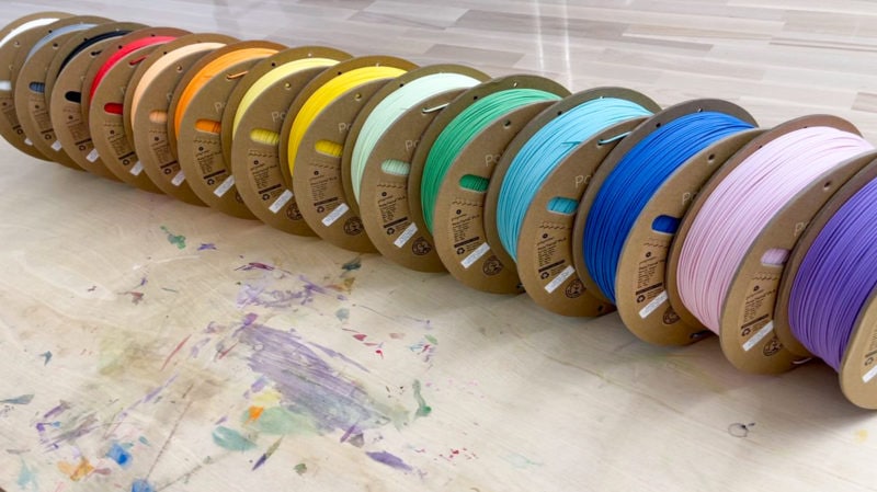 A collection of PLA filament spools in various colours