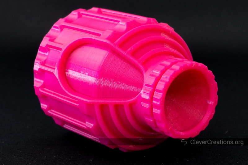 A closed pink planetary compartment container placed on its side