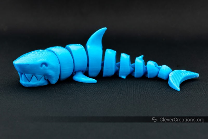 A 3D printed articulated shark in blue PLA