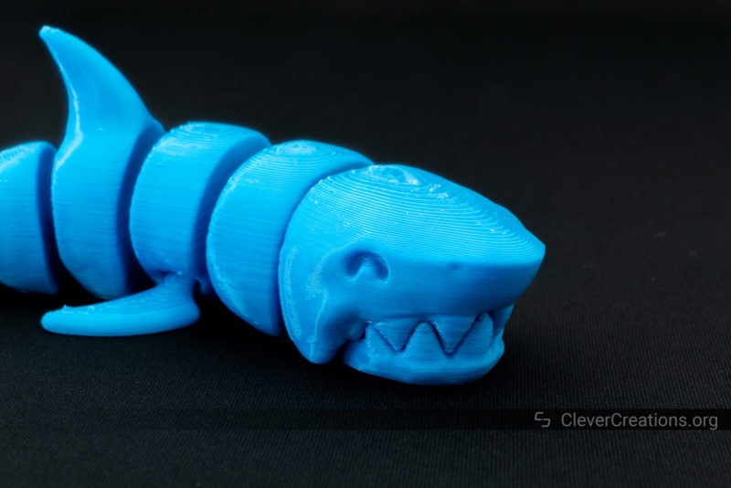 A 3D printed articulated shark in blue PLA