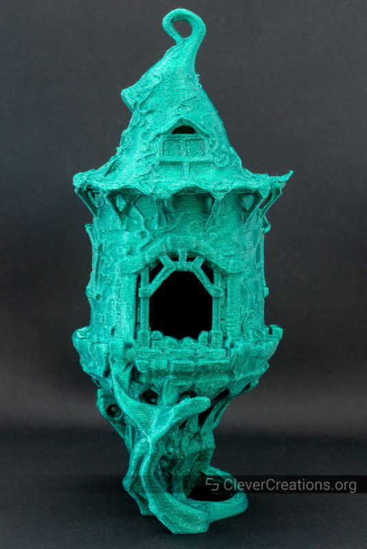 A 3D printed bird house in green glitter PLA
