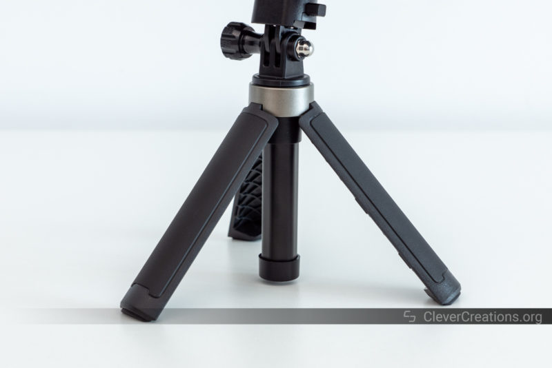 A close-up of a tripod with rubberized grip surface on its legs