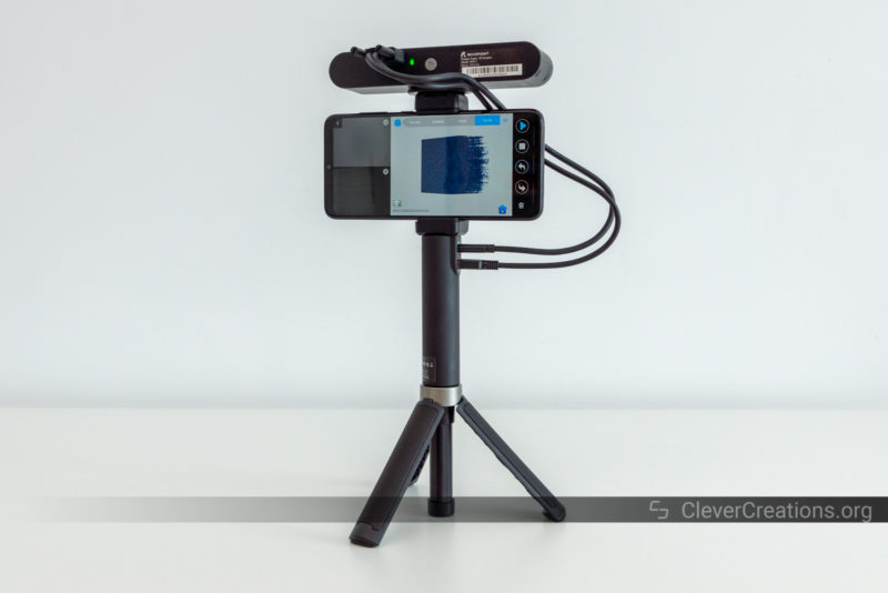 A phone, power bank, tripod and 3D scanner mounted together to create a mobile 3D scanning solution