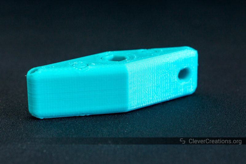 A 3D printed print-in-place ratchet screwdriver in blue PETG on a black background