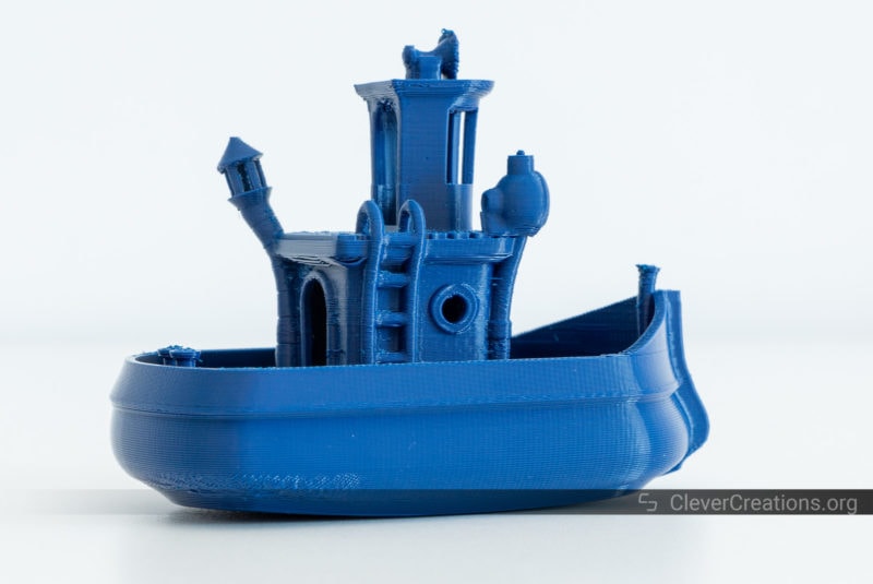 A 3D printed boat in blue ABS on a white background