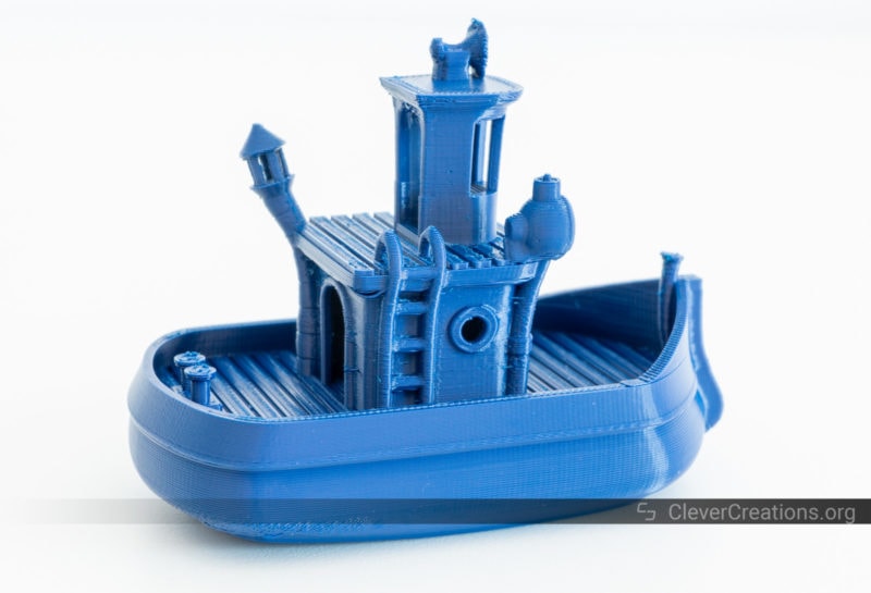 A 3D printed boat in blue ABS on a white background