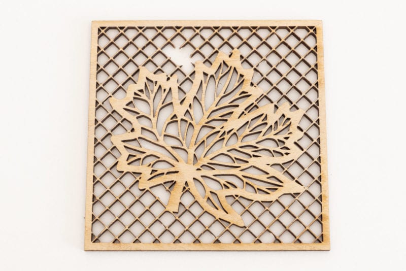 A laser cut leaf on a lattice background