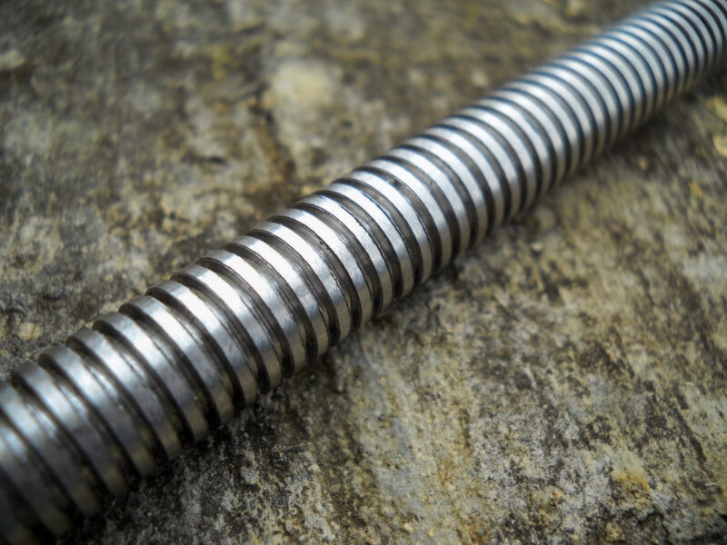 A lead screw on a wooden background