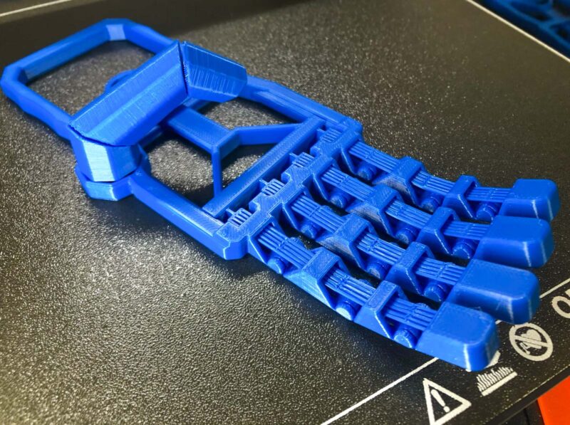 A blue plastic robotic print in place hand toy