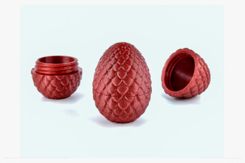 A red egg storage container with threads