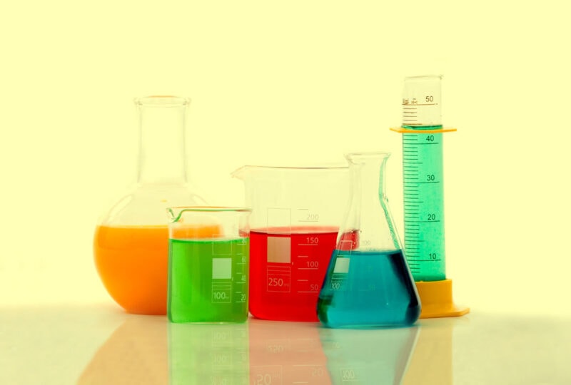 A collection of chemistry bottles with liquids inside for dissolving PLA