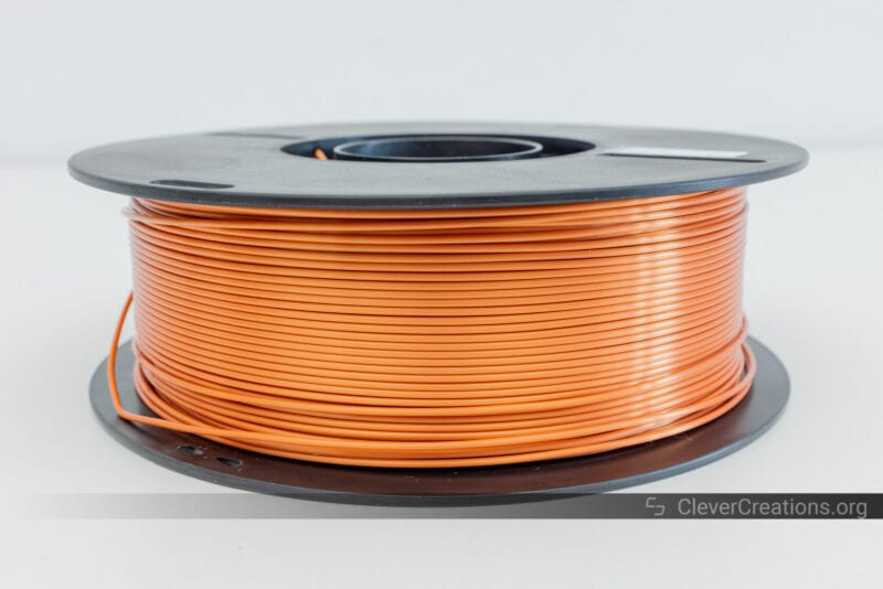 A roll of silk bronze PLA filament