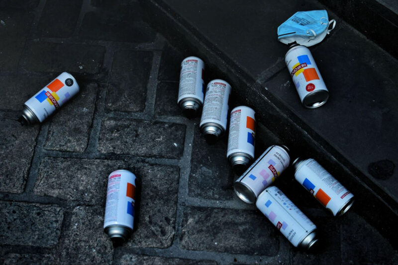 Various cans of spray paints on the ground