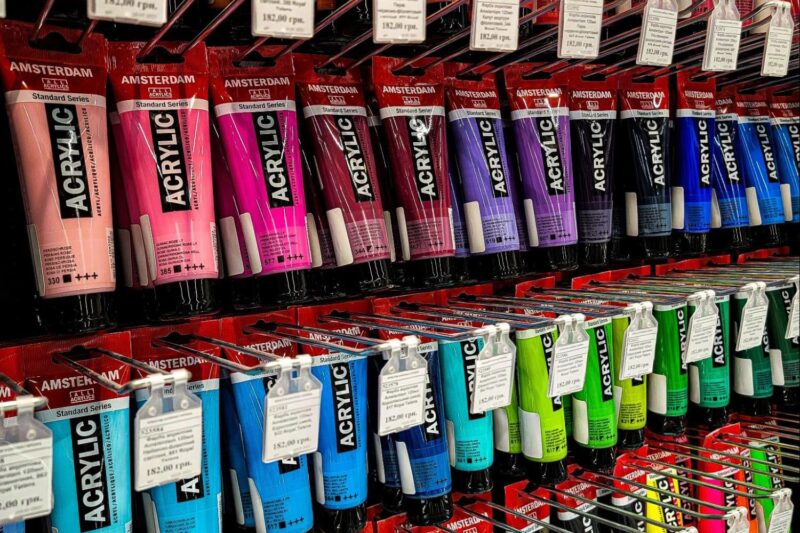 Rows of standard acrylic paint in various colors in a store display