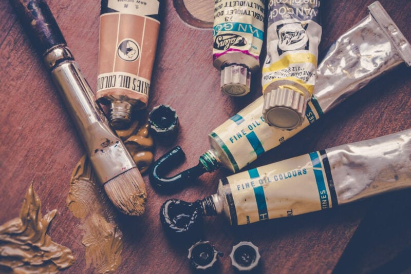 A collection of oil paints in tubes on a wooden surface