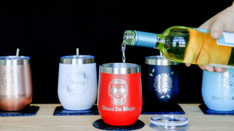 Laser engraved tumblers with one of them being filled with wine