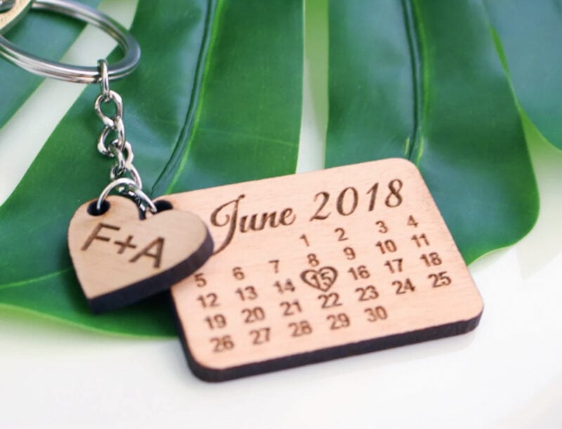 A custom wooden calendar on a keychain with 15 June 2018 circled