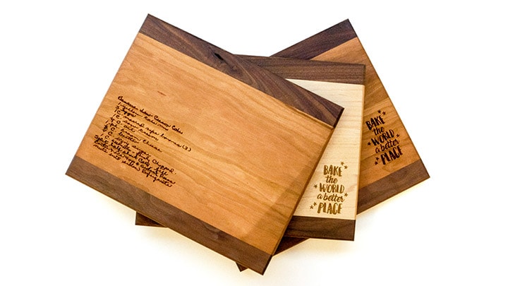 A set of cutting board with laser engraved text on them