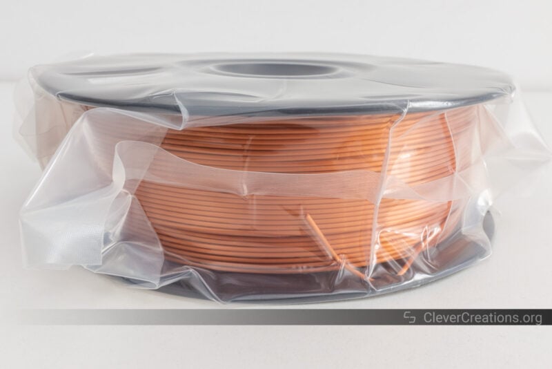 A fresh filament spool packed in protective plastic