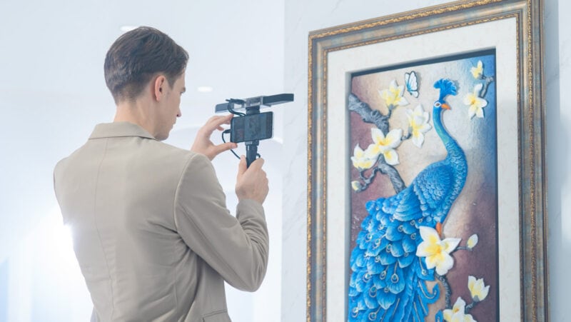 A Revopoint RANGE 3D scanner used to scan a painting of a blue bird