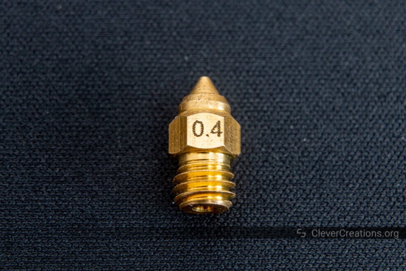 A 0.4mm 3D printer nozzle with its size engraved on the brass surface